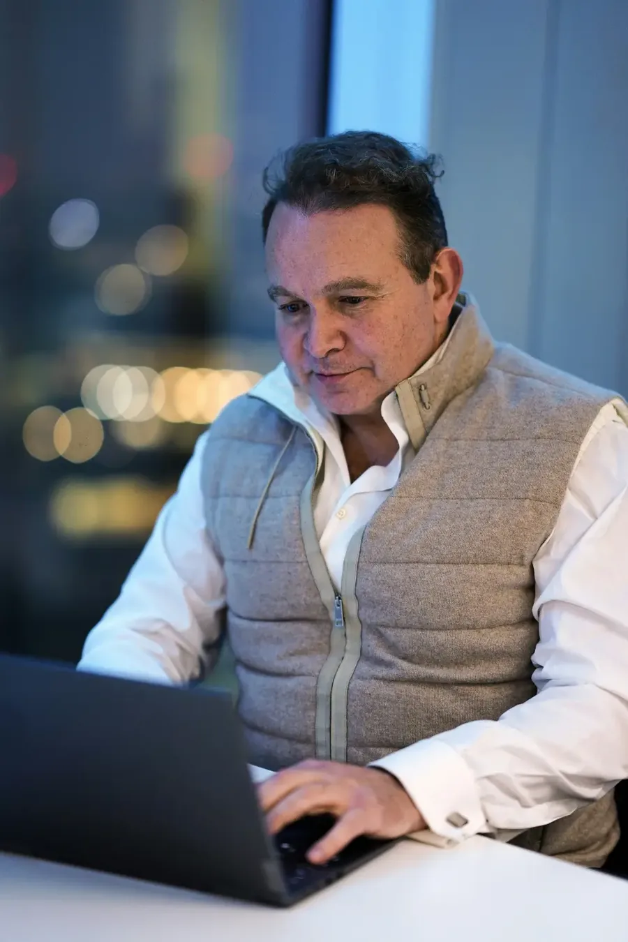 Small business owner focused on his laptop, working late